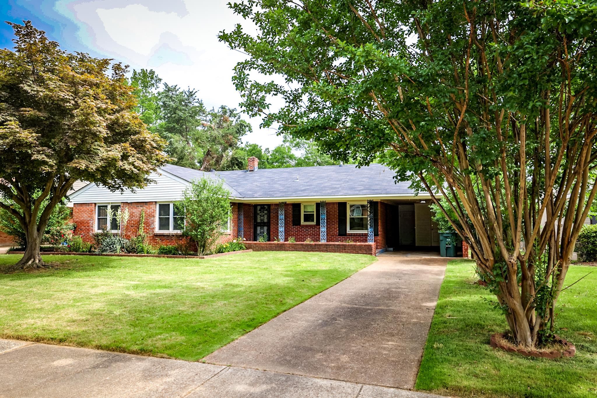 5136 Mason Road Memphis, TN 38117 - Photo 1 of 15 a front view of a house with a garden