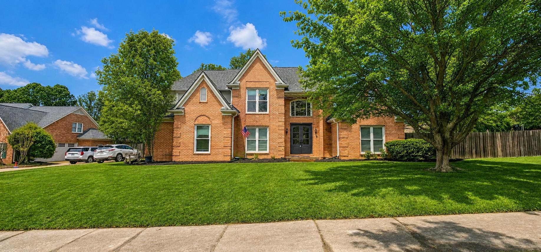 660 Weston Drive Collierville, TN 38017 - Photo 1 of 32 Traditional-style house with brick siding, a shingled roof, and a front lawn