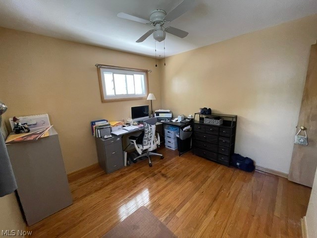 28634 Forest Road Willowick, OH 44095 - Photo 25 of 39 Room featuring wood-finish flooring, a ceiling fan, and a single window with wood trim