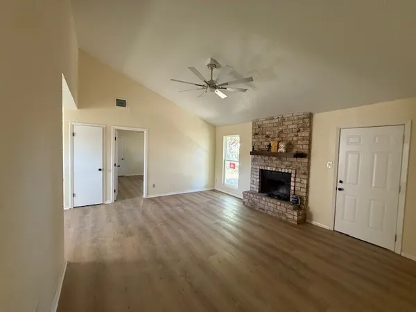 wooden floor in an empty room with a fireplace