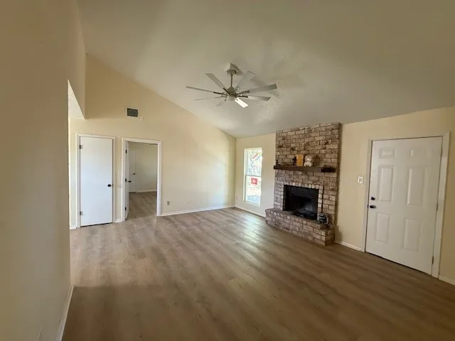 wooden floor in an empty room with a fireplace