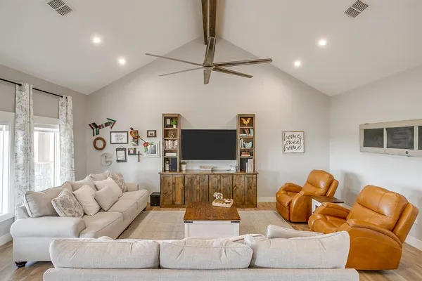a living room with furniture and a flat screen tv