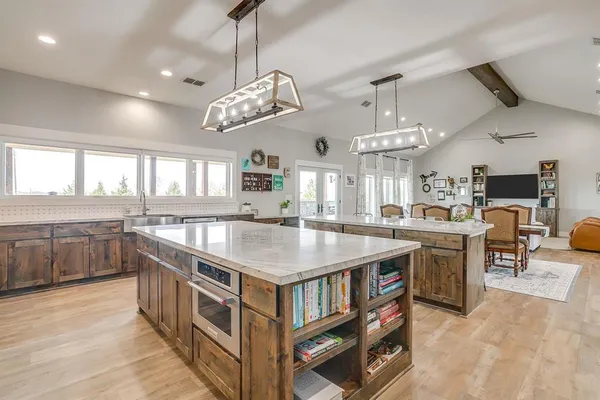a large kitchen with a counter space a sink and appliances