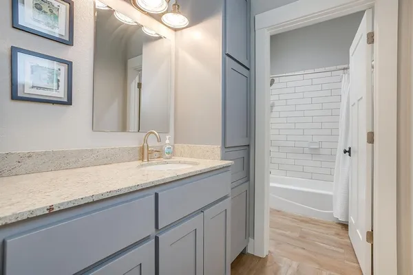 a bathroom with a granite countertop sink a mirror and a