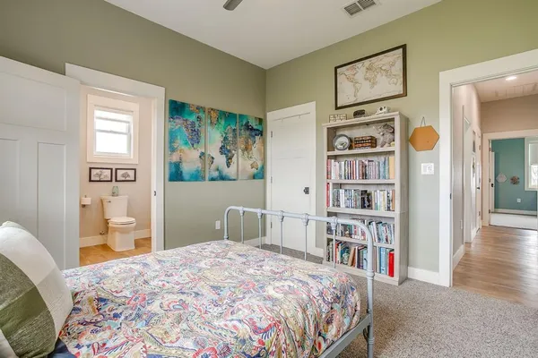 a bedroom with a bed and a book shelf