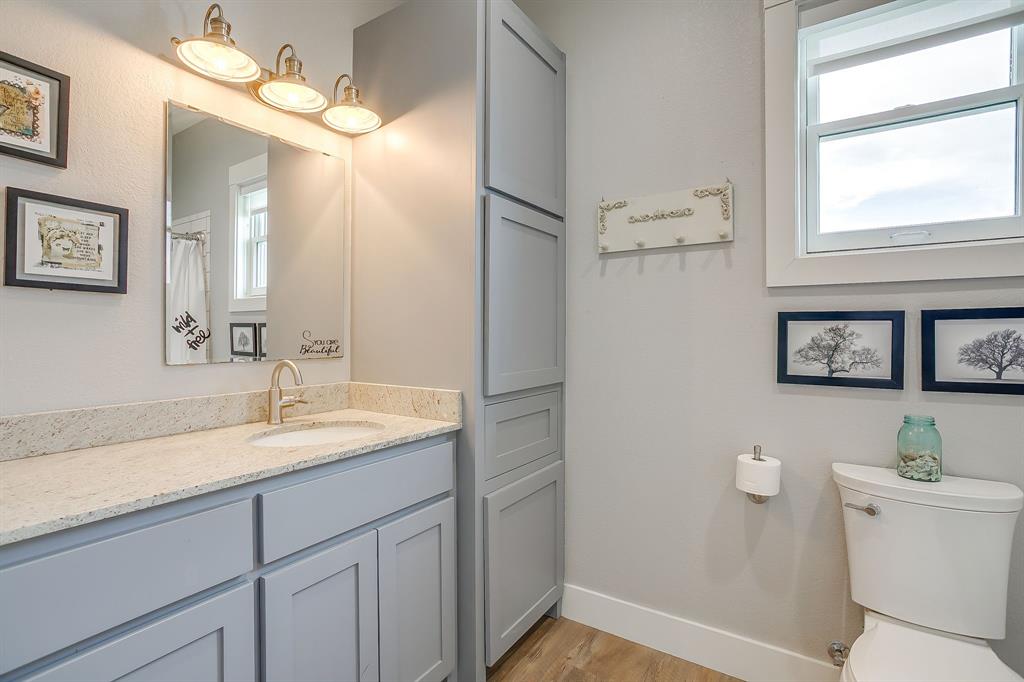 19611 North County Line Road Ponder, TX 76259 - Photo 30 of 40 a bathroom with a sink and a mirror