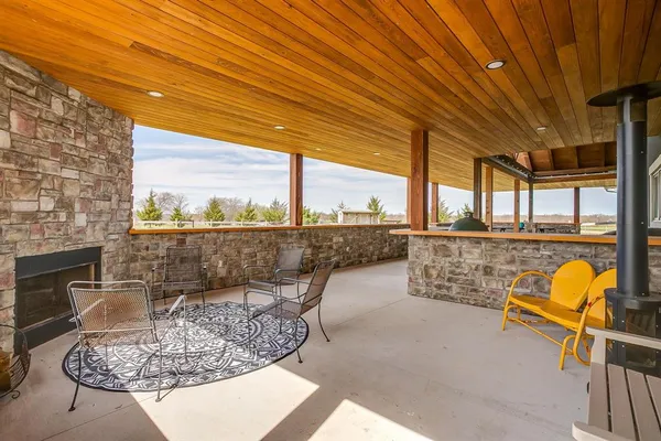 a building outdoor space with patio furniture and ocean view