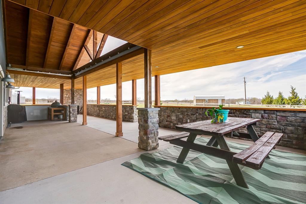 19611 North County Line Road Ponder, TX 76259 - Photo 35 of 40 a building outdoor space with patio furniture and ocean view