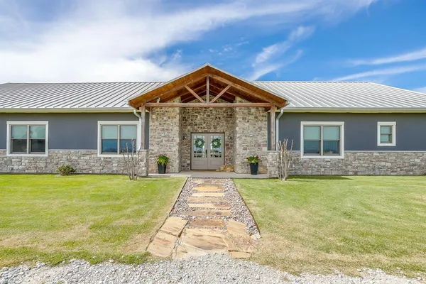 a front view of a house with swimming pool