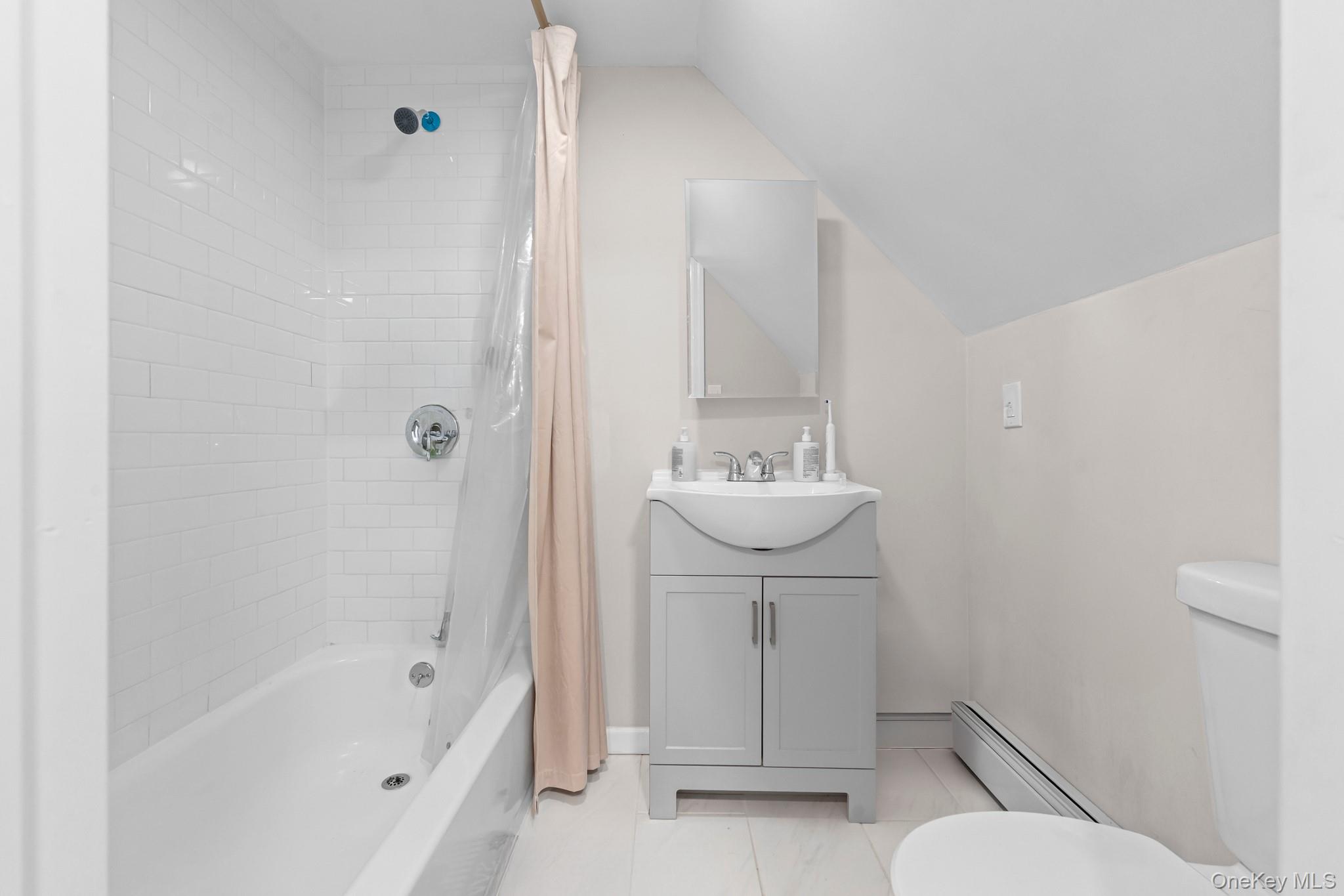 20 Dewitt Street Valley Stream, NY 11580 - Photo 10 of 13 a bathroom with a sink toilet a mirror and shower