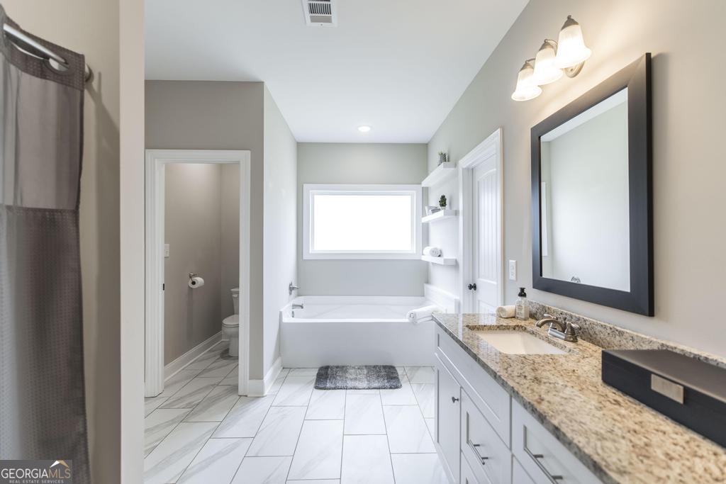 100 Sutter Butte Place Bonaire, GA 31005 - Photo 17 of 34 The luxurious ensuite bath features double vanities.
