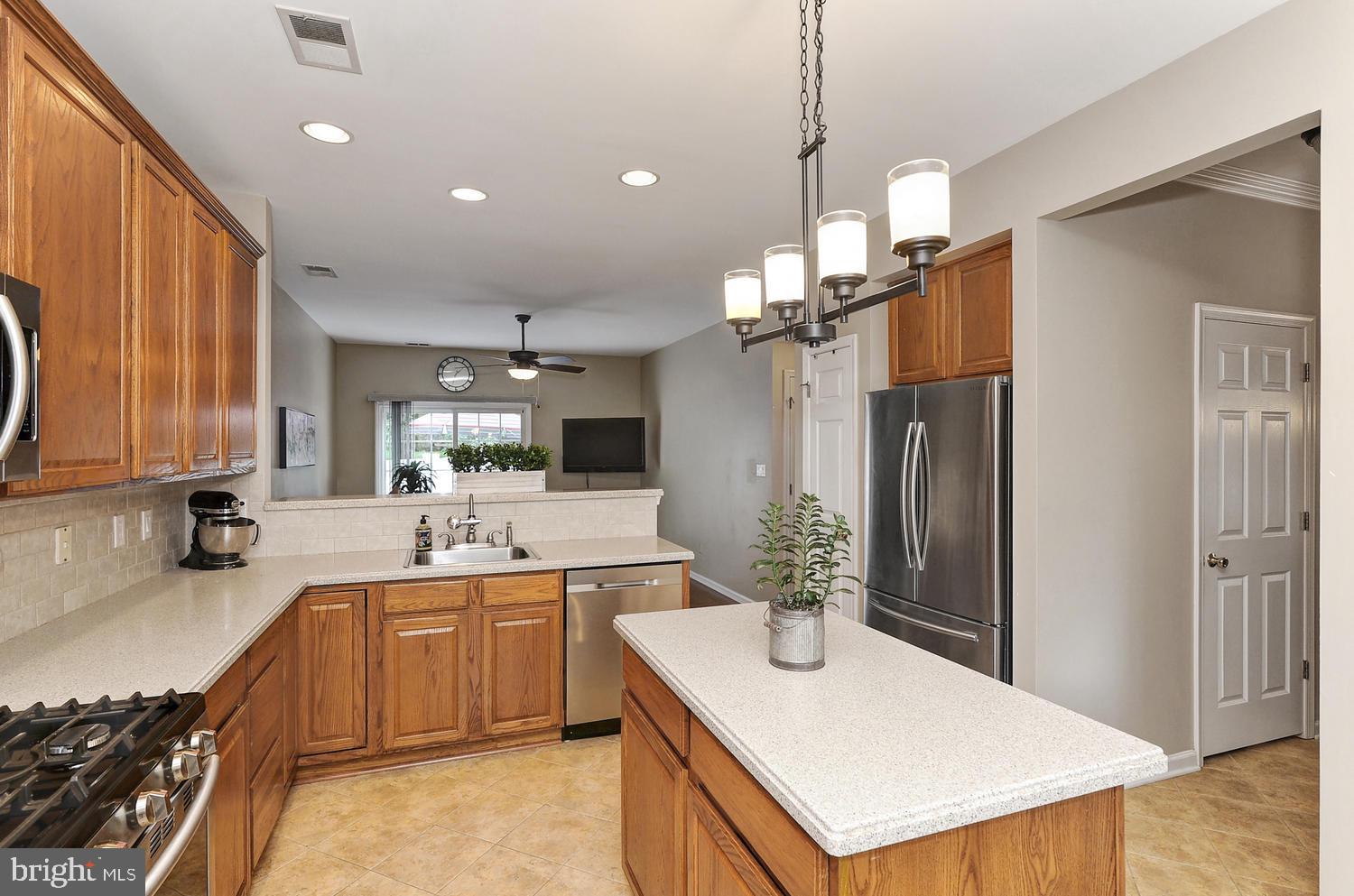 17 Windsor Pond Road Princeton Junction, NJ 08550 - Photo 2 of 20 a kitchen with a sink a counter top space stainless steel appliances and cabinets