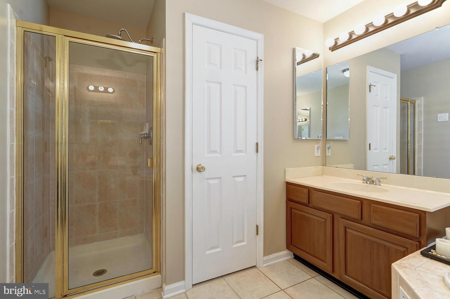 17 Windsor Pond Road Princeton Junction, NJ 08550 - Photo 14 of 20 a bathroom with a shower sink and mirror