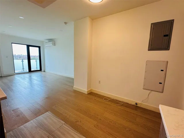 a view of a room with wooden floor and a window