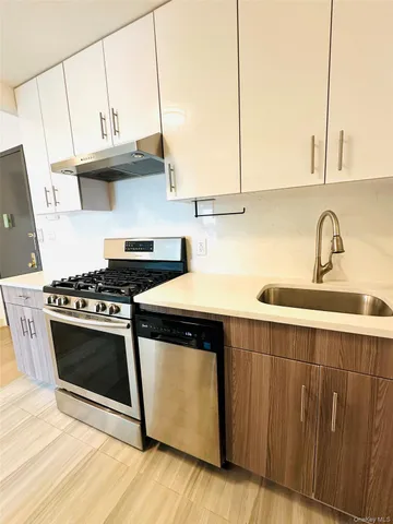a kitchen with stainless steel appliances a refrigerator and a stove