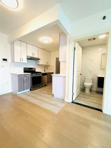 a view of a kitchen with a sink and a fireplace