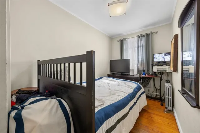 a bed room with a bed and a television