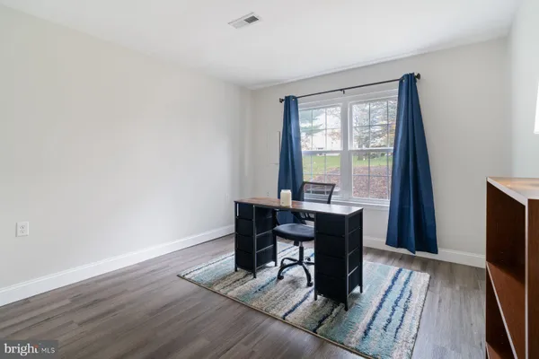 a workspace with furniture window and wooden floor