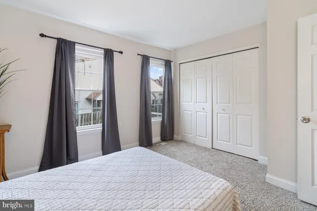 a bedroom with a bed and a mirror