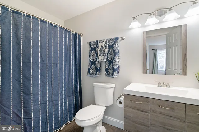 a bathroom with a toilet a sink and a mirror