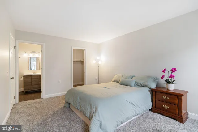 a bedroom with a bed and cabinets
