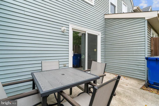 a backyard of a house with table and chairs