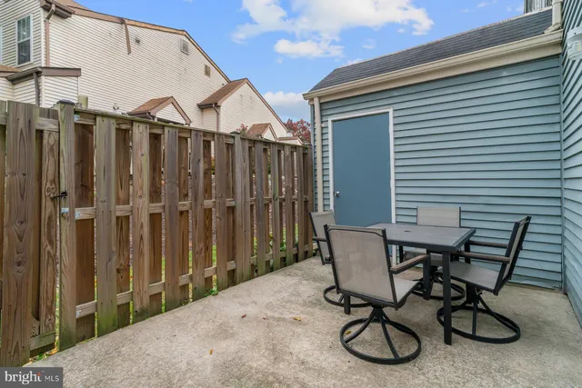 a view of a chair and table in backyard