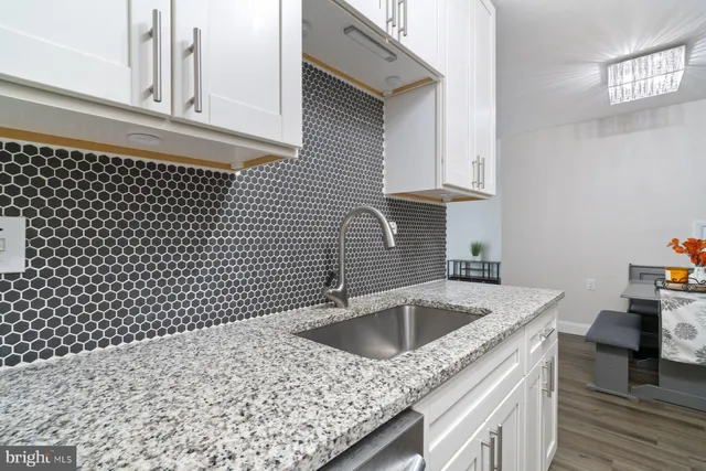 a kitchen with a sink cabinets and a stove
