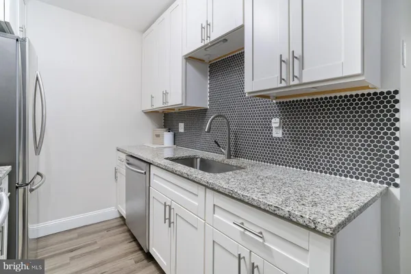a kitchen with a sink and cabinets