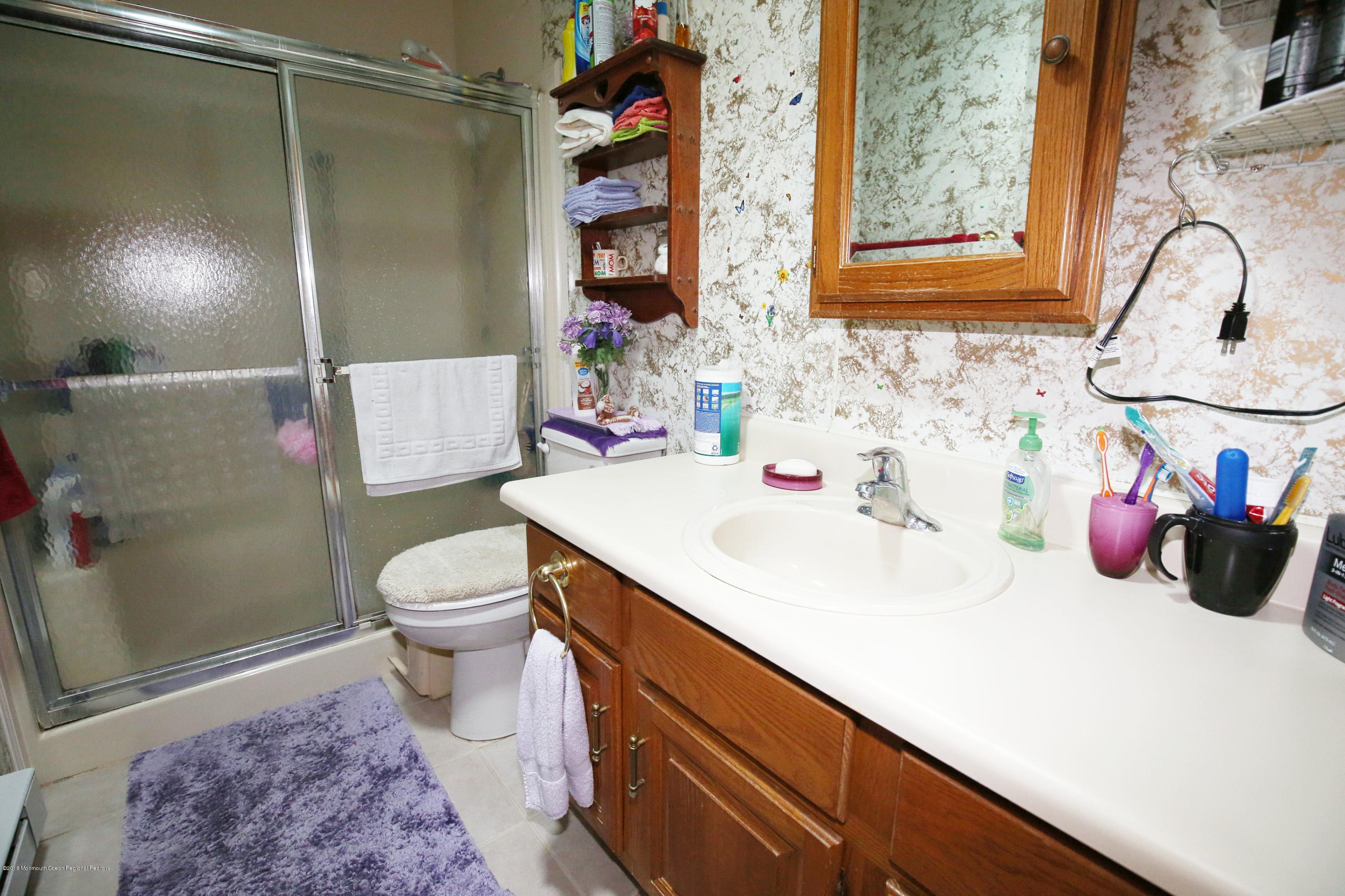 30A Mill Road, Unit C Whiting, NJ 08759 - Photo 13 of 23 a bathroom with a sink a toilet and shower