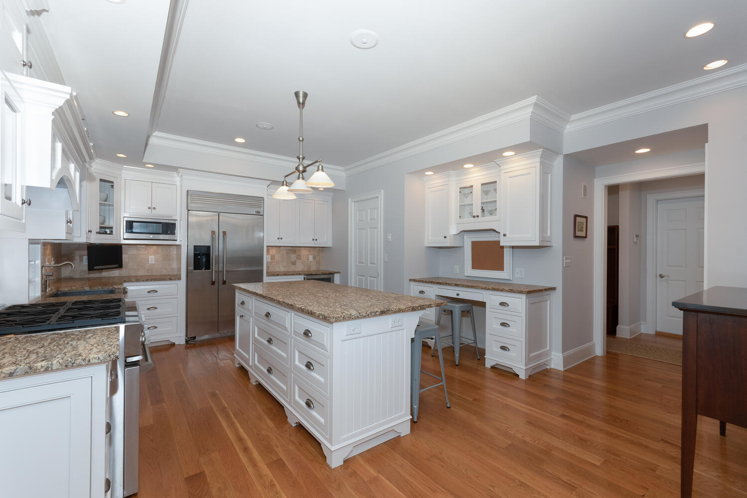 11 Harstrom Place Rowayton, CT 06853 - Photo 9 of 22 a large kitchen with stainless steel appliances a stove center island wooden floor and cabinets
