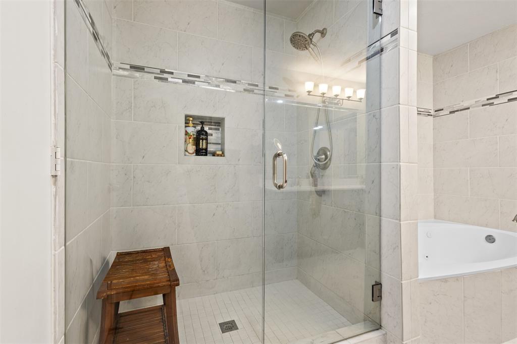 668 Cleve Cole Road Denison, TX 75021 - Photo 14 of 38 Enclosed shower with clear glass door, tile surround, recessed storage niche, and integrated showerhead
