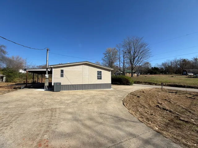 a view of a yard covered with snow in front of house