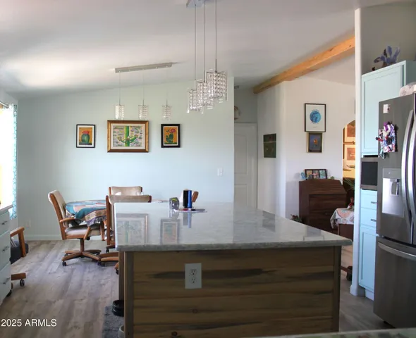 a kitchen with stainless steel appliances granite countertop a refrigerator and a stove
