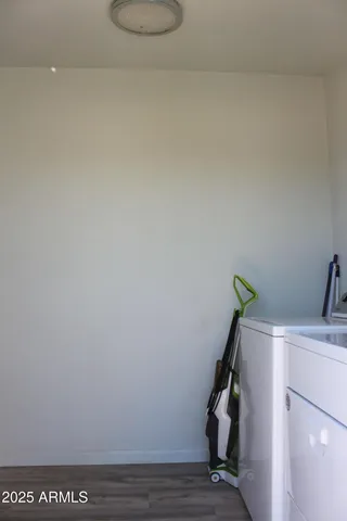 a roof deck with table and chairs a barbeque with wooden floor and fence