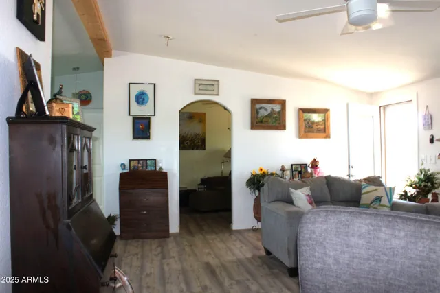 a front view of a house with a yard and potted plants