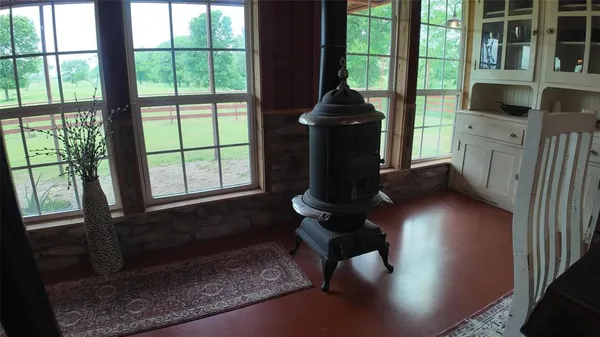 a living room with furniture wooden floor and a floor to ceiling window