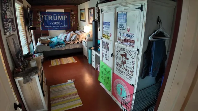 a hallway with painting on the wall and a potted plant