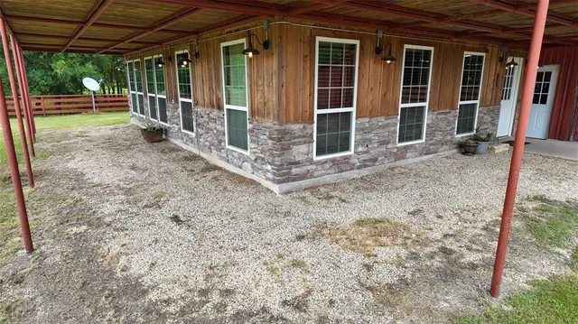 a view of a backyard with wooden fence