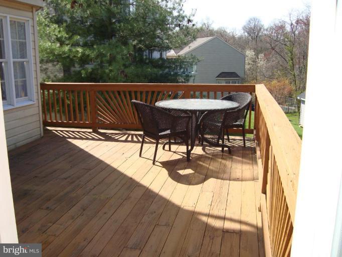 10 Trumpet Court Nottingham, MD 21236 - Photo 13 of 17 a view of a roof deck with table and chairs with wooden floor