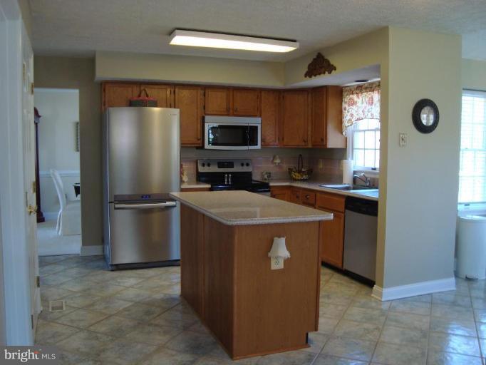10 Trumpet Court Nottingham, MD 21236 - Photo 3 of 17 a kitchen with a refrigerator a sink and a stove