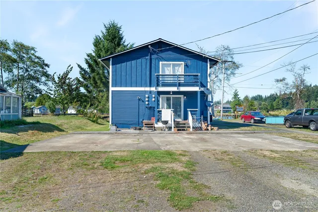 a view of a house with a yard and garage