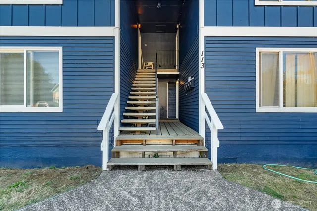 a view of front door and potted plants