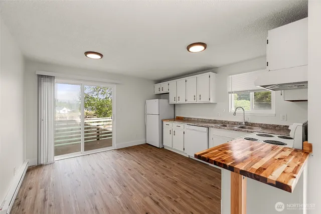 a kitchen with granite countertop a stove and a sink