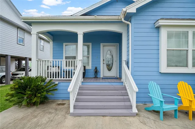 a view of a house with a deck and furniture