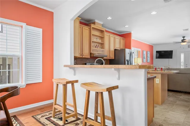 a kitchen with stainless steel appliances kitchen island granite countertop a sink and cabinets