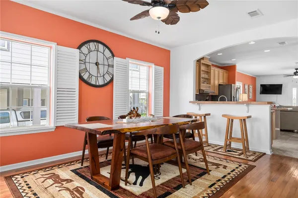 a view of a dining room with furniture window and wooden floor