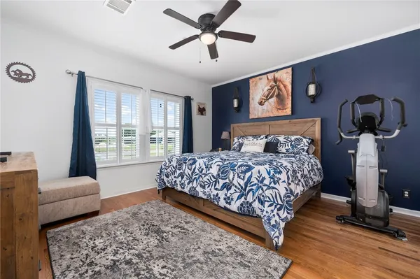 a bedroom with a bed a couch and a window