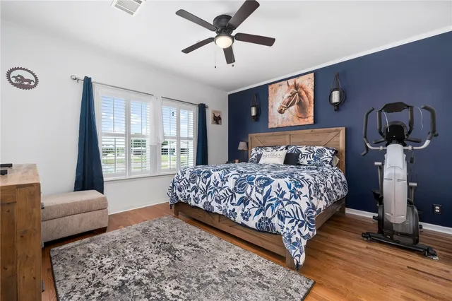 a bedroom with a bed a couch and a window