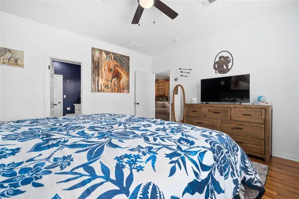 a bedroom with a bed and a flat screen tv